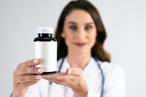 Doctor's hand holding medicament in bottle
